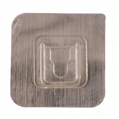 Close-up of sticky transparent wall hook installation